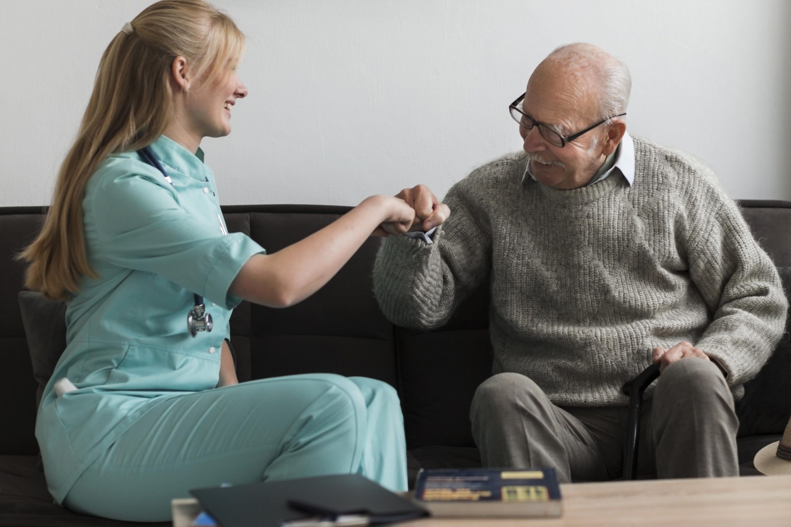 old-man-nursing-home-fist-bumping-nurse